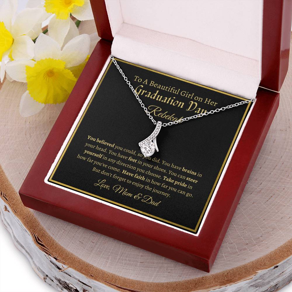 To A Beautiful Girl On Her Graduation Day -  Ribbon Necklace - Love Mom & Dad Alluring Beauty Necklace